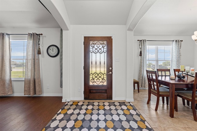 104 Knoll Ln, Decatur, TX 76234 - entrance foyer with healthy amount of natural light, arched walkways, and wood finished floors