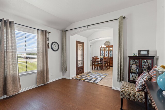 104 Knoll Ln, Decatur, TX 76234 - foyer with arched walkways, wood finished floors, lofted ceiling, and a chandelier