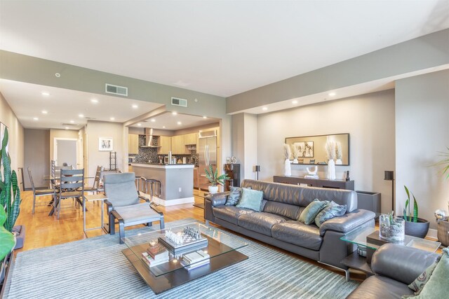 5055 Addison Cir Unit 413, Addison, TX 75001 - living area featuring light wood finished floors and recessed lighting