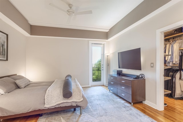 5055 Addison Cir Unit 413, Addison, TX 75001 - bedroom with access to outside, light wood-type flooring, a spacious closet, and ceiling fan