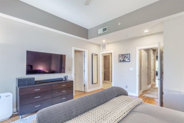 5055 Addison Cir Unit 413, Addison, TX 75001 - bedroom featuring light wood-type flooring, recessed lighting, a ceiling fan, and connected bathroom