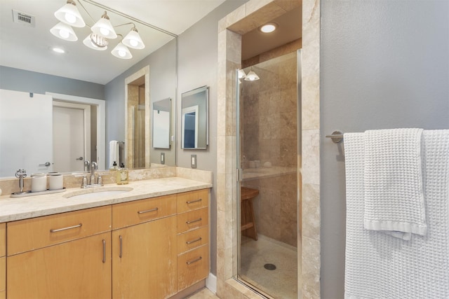 5055 Addison Cir Unit 413, Addison, TX 75001 - bathroom with vanity, a shower stall, and a chandelier