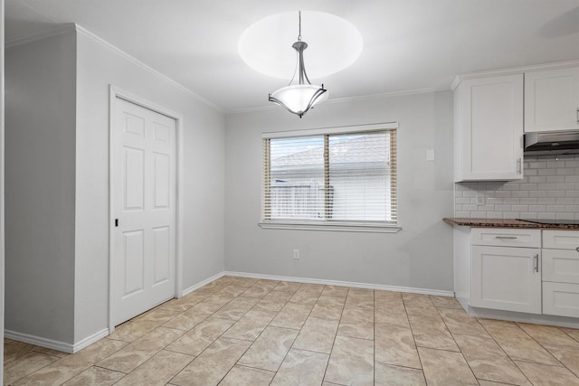 7422 Foxworth Dr, Dallas, TX 75248 - unfurnished dining area with crown molding and baseboards