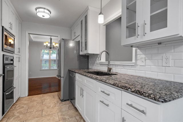7422 Foxworth Dr, Dallas, TX 75248 - kitchen with a chandelier, appliances with stainless steel finishes, and white cabinetry