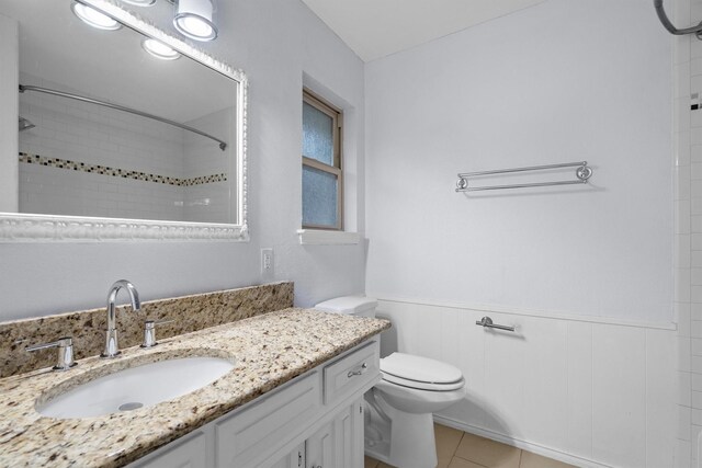 7422 Foxworth Dr, Dallas, TX 75248 - bathroom with vanity, tiled shower, wainscoting, and tile patterned floors