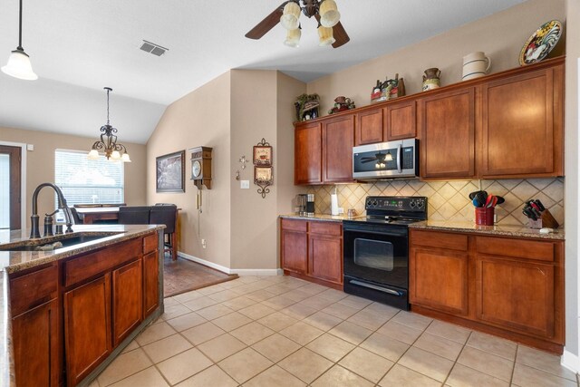 2912 Day Star Dr, Little Elm, TX 75068 - kitchen with stainless steel microwave, black / electric stove, tasteful backsplash, lofted ceiling, and ceiling fan