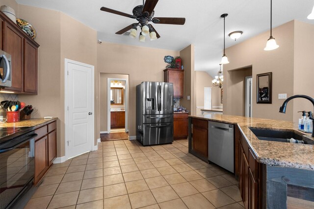 2912 Day Star Dr, Little Elm, TX 75068 - kitchen with appliances with stainless steel finishes, light tile patterned floors, a ceiling fan, decorative light fixtures, and light stone countertops