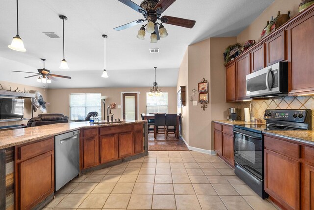 2912 Day Star Dr, Little Elm, TX 75068 - kitchen with stainless steel appliances, a ceiling fan, tasteful backsplash, pendant lighting, and light tile patterned floors