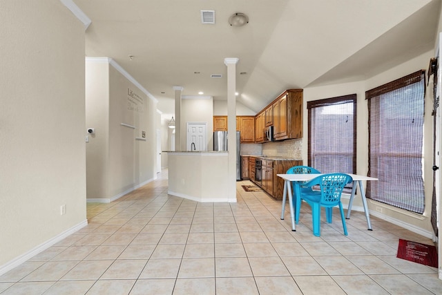12313 Ark Rd, Frisco, TX 75035 - kitchen featuring light tile patterned floors, tasteful backsplash, appliances with stainless steel finishes, brown cabinetry, and a center island