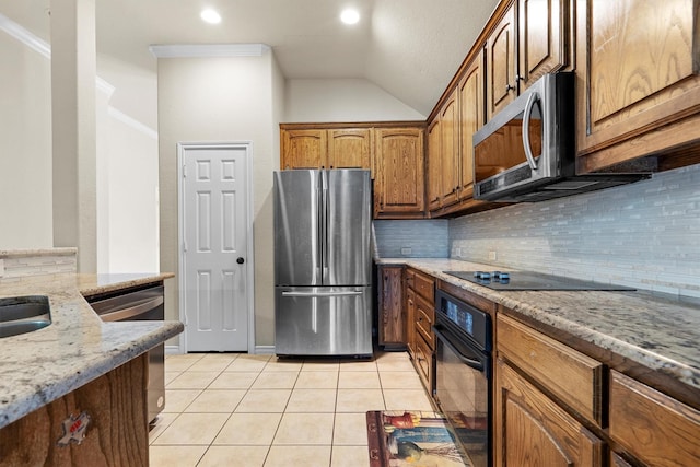 12313 Ark Rd, Frisco, TX 75035 - kitchen with black appliances, tasteful backsplash, light stone countertops, light tile patterned flooring, and lofted ceiling