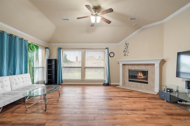 12313 Ark Rd, Frisco, TX 75035 - living room featuring lofted ceiling, ceiling fan, wood finished floors, a fireplace, and crown molding