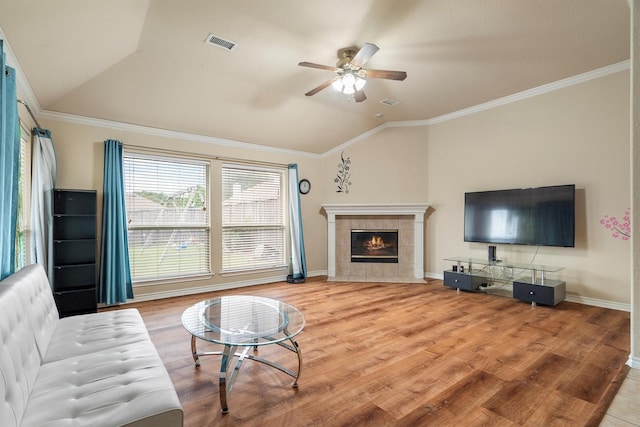 12313 Ark Rd, Frisco, TX 75035 - living area with lofted ceiling, ceiling fan, wood finished floors, a fireplace, and ornamental molding
