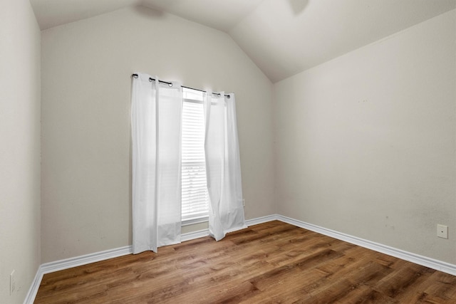 12313 Ark Rd, Frisco, TX 75035 - empty room featuring lofted ceiling and wood finished floors