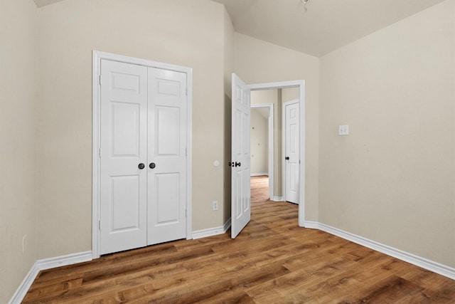 12313 Ark Rd, Frisco, TX 75035 - unfurnished bedroom with vaulted ceiling, wood finished floors, and a closet