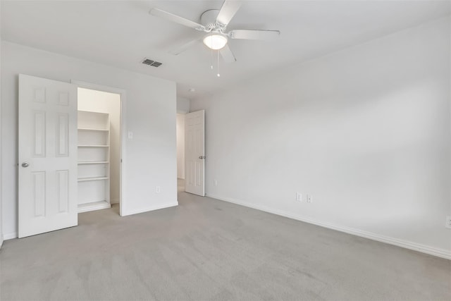831 Fair Oaks Dr, Grand Prairie, TX 75052 - unfurnished bedroom with carpet, a spacious closet, a ceiling fan, and a closet