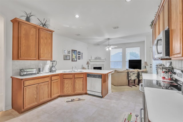 831 Fair Oaks Dr, Grand Prairie, TX 75052 - kitchen featuring appliances with stainless steel finishes, a ceiling fan, open floor plan, a peninsula, and tasteful backsplash