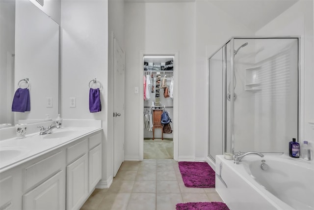 831 Fair Oaks Dr, Grand Prairie, TX 75052 - bathroom featuring a stall shower, tile patterned floors, double vanity, a walk in closet, and a bath
