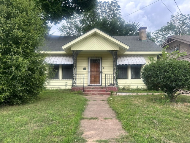 2806 Twyman, Dallas, TX 75215 - bungalow-style home with a front yard, a chimney, and a shingled roof