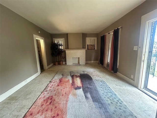2806 Twyman, Dallas, TX 75215 - unfurnished living room featuring carpet flooring and a fireplace