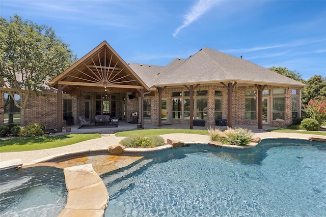 3030 Pecan Grove Ln, Celina, TX 75078 - back of property with a patio, brick siding, an outdoor pool, and a shingled roof