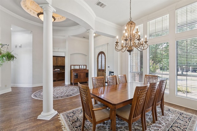 3030 Pecan Grove Ln, Celina, TX 75078 - dining space featuring decorative columns, ornamental molding, dark wood-style flooring, arched walkways, and a chandelier
