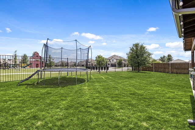 405 Milford, Wylie, TX 75098 - fenced backyard featuring a trampoline and a playground