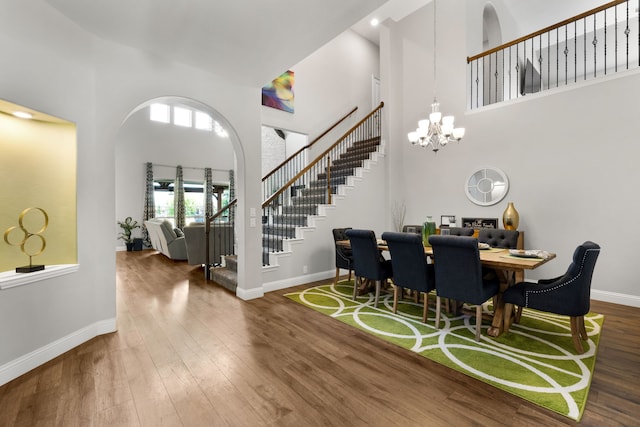 405 Milford, Wylie, TX 75098 - dining space featuring a high ceiling, stairway, wood finished floors, and a chandelier