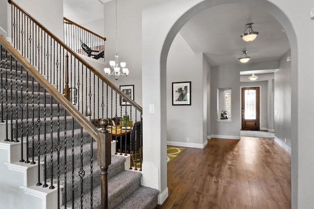 405 Milford, Wylie, TX 75098 - foyer entrance with wood-type flooring, stairs, a chandelier, and arched walkways