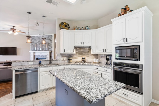 3718 Colonnade Grove Dr, Frisco, TX 75033 - kitchen featuring appliances with stainless steel finishes, open floor plan, ceiling fan, a peninsula, and white cabinets