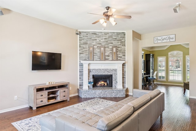3718 Colonnade Grove Dr, Frisco, TX 75033 - living room featuring ceiling fan, crown molding, a tiled fireplace, and wood finished floors