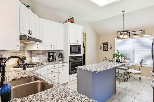 3718 Colonnade Grove Dr, Frisco, TX 75033 - kitchen with appliances with stainless steel finishes, under cabinet range hood, white cabinets, decorative backsplash, and a chandelier