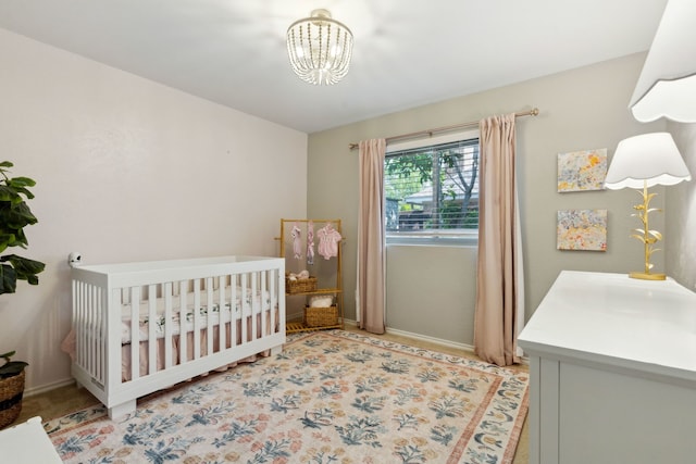 3505 Bentley Ct, Plano, TX 75093 - bedroom featuring a chandelier and a crib