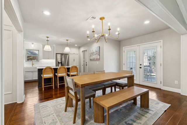 3505 Bentley Ct, Plano, TX 75093 - dining space with a chandelier, dark wood-style flooring, recessed lighting, and french doors