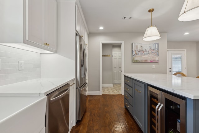 3505 Bentley Ct, Plano, TX 75093 - kitchen featuring appliances with stainless steel finishes, wine cooler, dark wood-style floors, white cabinetry, and recessed lighting