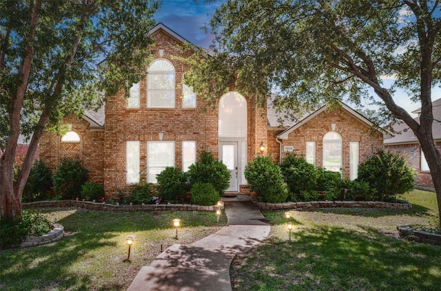 8224 Spring Valley Ln, Plano, TX 75025 - traditional-style house with a front lawn and brick siding