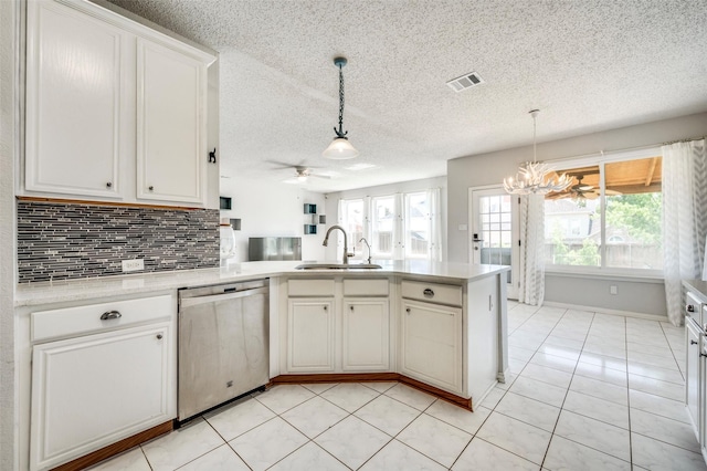 8224 Spring Valley Ln, Plano, TX 75025 - kitchen featuring stainless steel dishwasher, healthy amount of natural light, a peninsula, a ceiling fan, and a textured ceiling