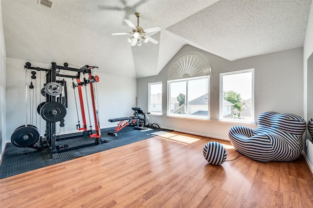 8224 Spring Valley Ln, Plano, TX 75025 - exercise area featuring a textured ceiling, a ceiling fan, wood finished floors, and lofted ceiling