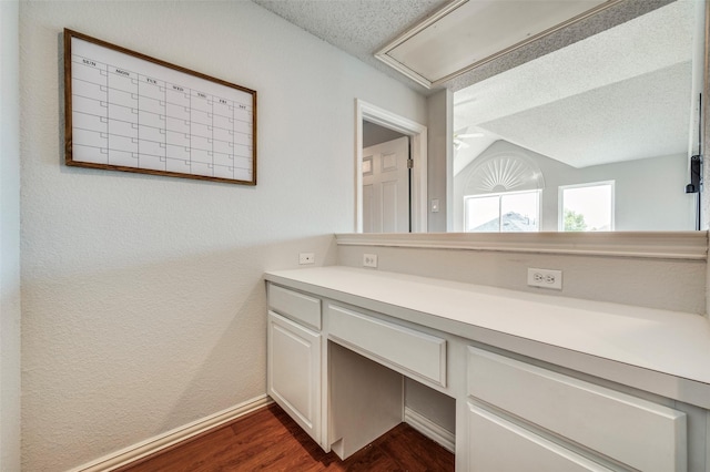 8224 Spring Valley Ln, Plano, TX 75025 - bathroom featuring a textured ceiling, wood finished floors, vaulted ceiling, and vanity
