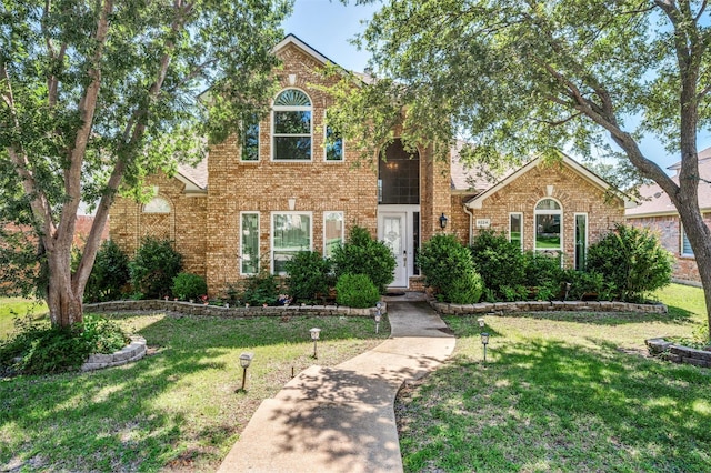 8224 Spring Valley Ln, Plano, TX 75025 - traditional-style home featuring brick siding and a front lawn