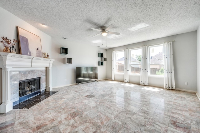 8224 Spring Valley Ln, Plano, TX 75025 - unfurnished living room featuring ceiling fan, a high end fireplace, and a textured ceiling