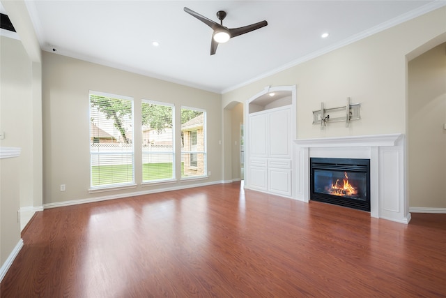 5853 Echo Bluff Dr, Haltom City, TX 76137 - unfurnished living room featuring ceiling fan, a glass covered fireplace, wood finished floors, crown molding, and recessed lighting