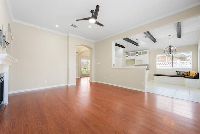 5853 Echo Bluff Dr, Haltom City, TX 76137 - unfurnished living room featuring arched walkways, a ceiling fan, light wood finished floors, plenty of natural light, and ornamental molding