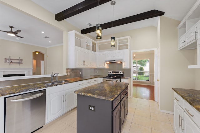 5853 Echo Bluff Dr, Haltom City, TX 76137 - kitchen featuring appliances with stainless steel finishes, under cabinet range hood, white cabinets, light tile patterned floors, and beamed ceiling