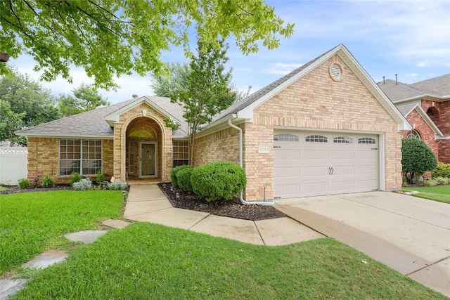 5853 Echo Bluff Dr, Haltom City, TX 76137 - view of front of property featuring a garage, driveway, roof with shingles, and brick siding