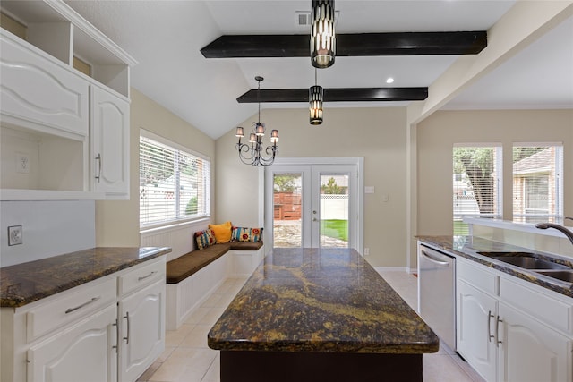 5853 Echo Bluff Dr, Haltom City, TX 76137 - kitchen with dishwasher, a center island, french doors, light tile patterned floors, and dark stone countertops