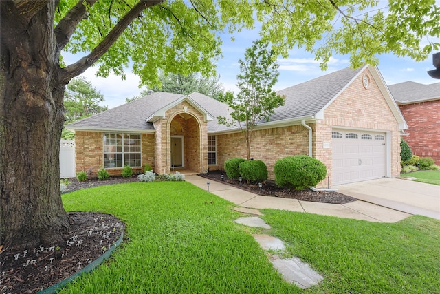 5853 Echo Bluff Dr, Haltom City, TX 76137 - view of front facade featuring a shingled roof, brick siding, a garage, and a front yard