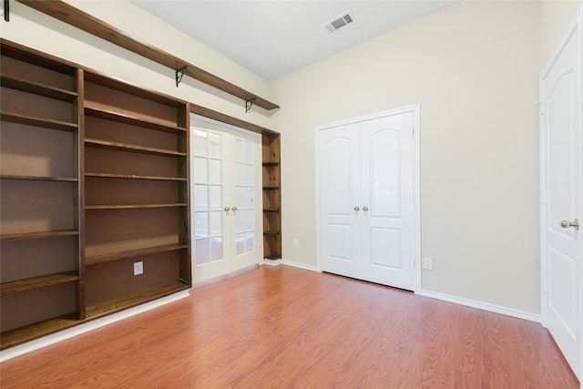 5853 Echo Bluff Dr, Haltom City, TX 76137 - unfurnished bedroom with french doors and wood finished floors