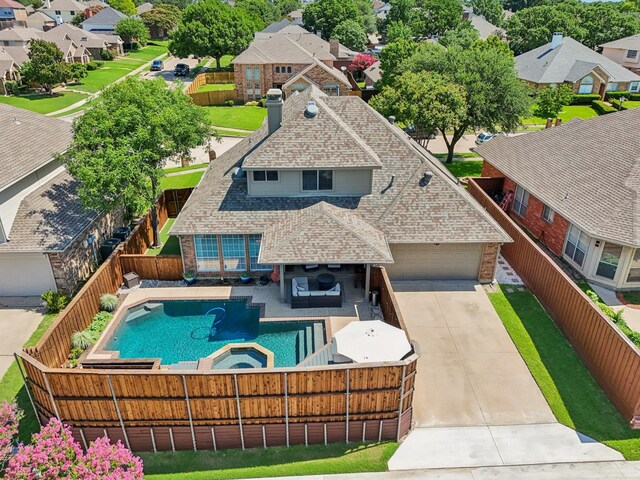 3707 Elizabeth Dr, Carrollton, TX 75007 - view of swimming pool featuring a fenced backyard, a residential view, and a pool with connected hot tub