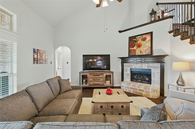 5413 Percy Priest St, Fort Worth, TX 76179 - living room featuring high vaulted ceiling, wood finished floors, arched walkways, a ceiling fan, and a fireplace with raised hearth