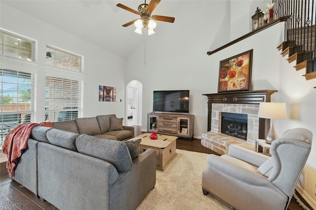 5413 Percy Priest St, Fort Worth, TX 76179 - living room featuring arched walkways, high vaulted ceiling, ceiling fan, wood finished floors, and a fireplace